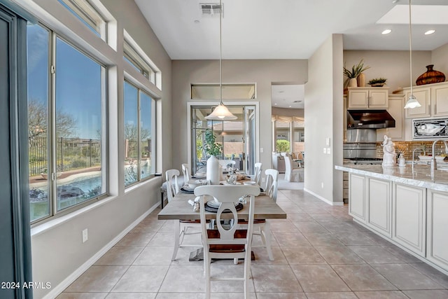 dining room featuring sink and light tile patterned floors