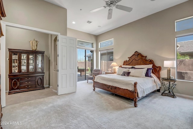 carpeted bedroom featuring multiple windows, access to outside, and ceiling fan