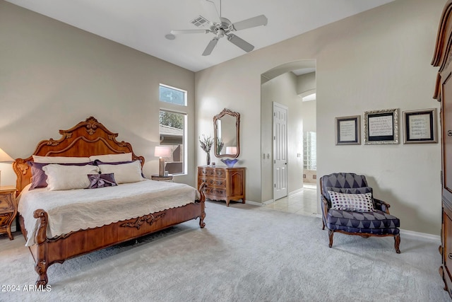 bedroom with ceiling fan and light carpet