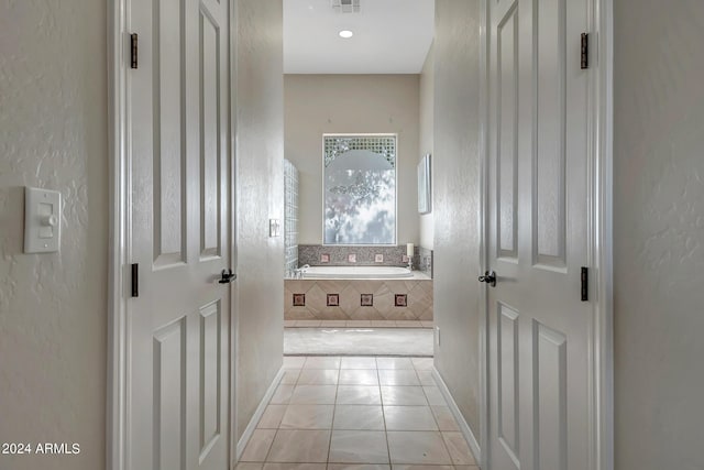 corridor featuring light tile patterned floors