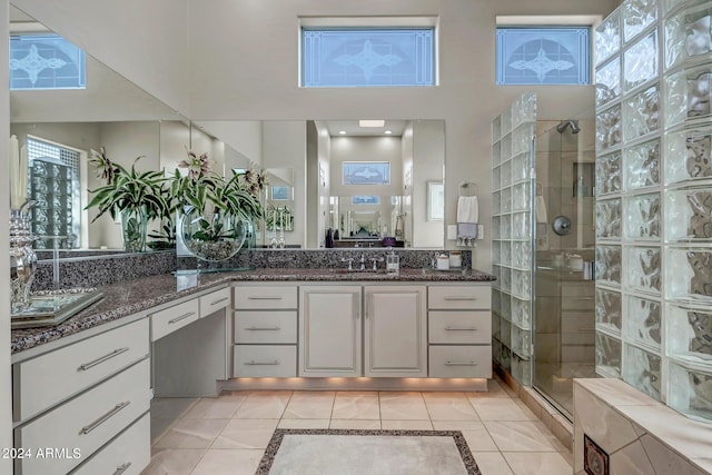 bathroom featuring walk in shower, tile patterned floors, and vanity