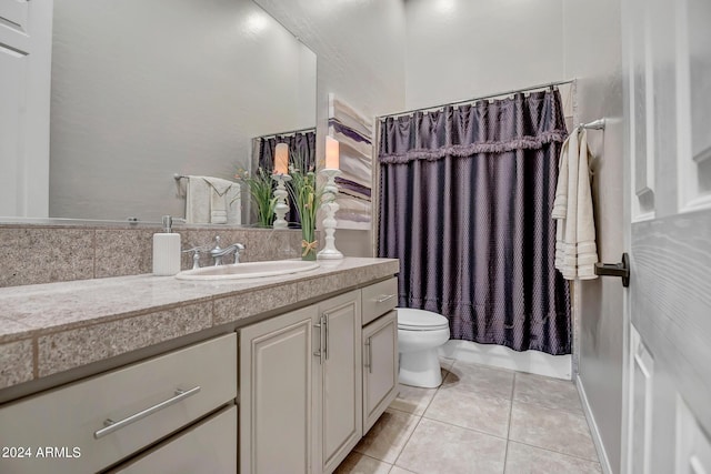 full bathroom with vanity, shower / tub combo with curtain, tile patterned floors, and toilet