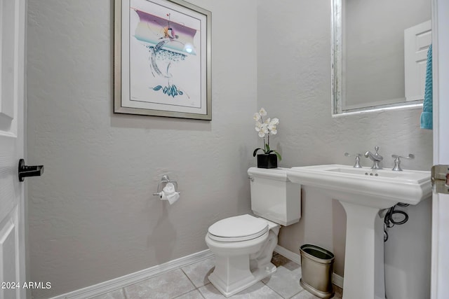 bathroom featuring tile patterned flooring, sink, and toilet