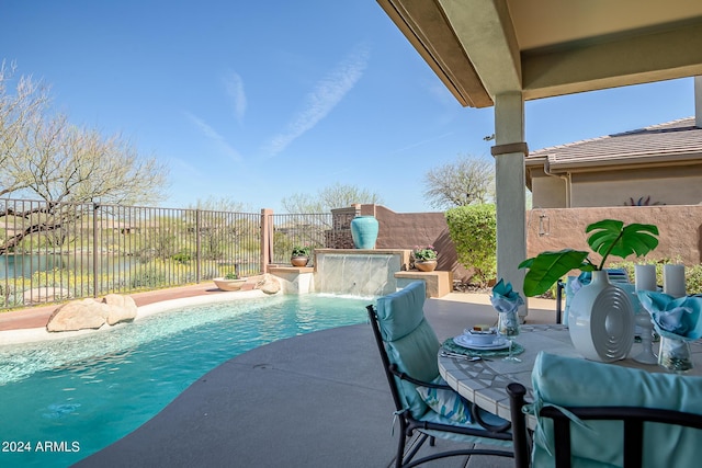 view of pool with a patio and pool water feature