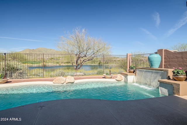 view of swimming pool featuring a water view and pool water feature