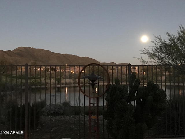 gate at dusk with a water and mountain view