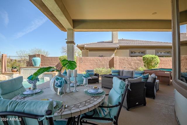 view of patio with a hot tub and outdoor lounge area