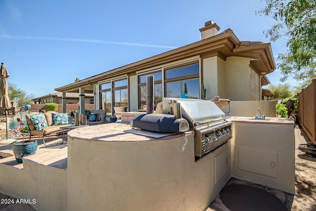 view of patio with area for grilling, sink, and grilling area