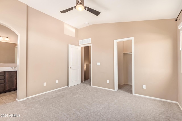 2725 E Mine Creek Rd Unit 1149, Phoenix, AZ 85024 - unfurnished bedroom with carpet, arched walkways, connected bathroom, a walk in closet, and high vaulted ceiling
