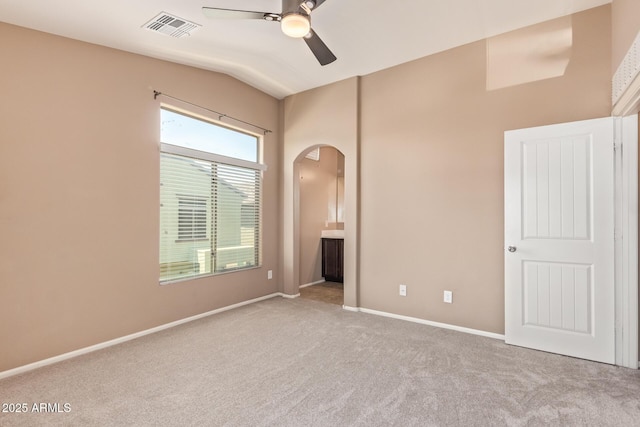 2725 E Mine Creek Rd Unit 1149, Phoenix, AZ 85024 - unfurnished bedroom with arched walkways, carpet floors, lofted ceiling, ensuite bath, and a ceiling fan