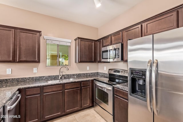 2725 E Mine Creek Rd Unit 1149, Phoenix, AZ 85024 - kitchen with stainless steel appliances, dark brown cabinets, light tile patterned floors, and dark stone countertops
