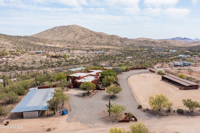 birds eye view of property with a mountain view and view of desert
