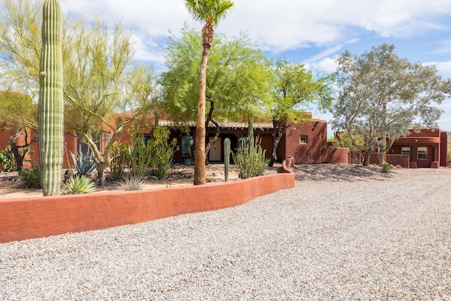 pueblo-style home with stucco siding