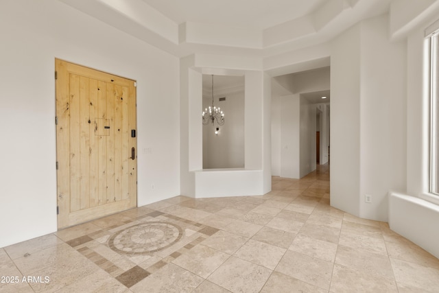 spare room with an inviting chandelier