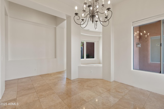unfurnished dining area with stone finish floor and a notable chandelier
