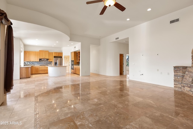 unfurnished living room with a ceiling fan, recessed lighting, and visible vents