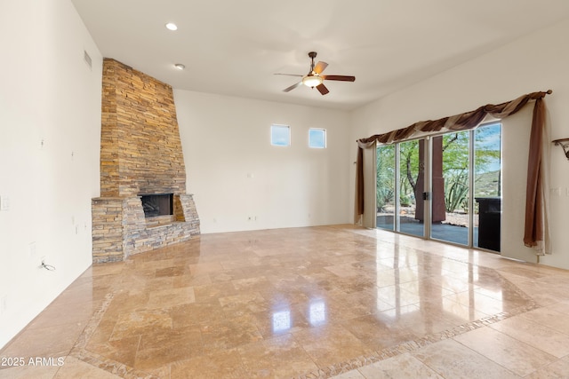 unfurnished living room with a stone fireplace, recessed lighting, and ceiling fan