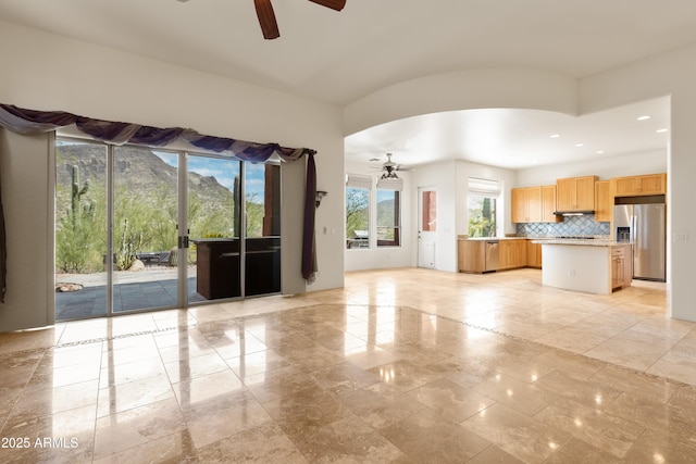 unfurnished living room with baseboards, ceiling fan, and recessed lighting