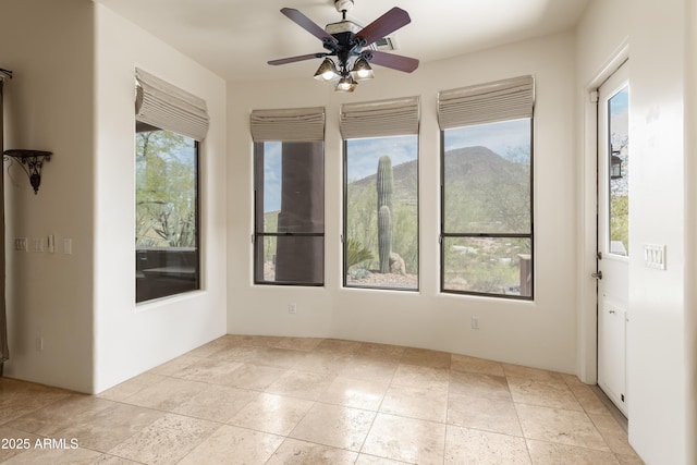 spare room with plenty of natural light and a ceiling fan