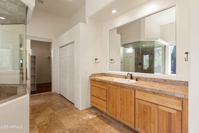 bathroom featuring a closet, recessed lighting, an enclosed shower, and vanity