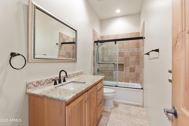 bathroom with shower / bath combination with glass door, toilet, and vanity