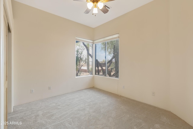 carpeted empty room featuring ceiling fan