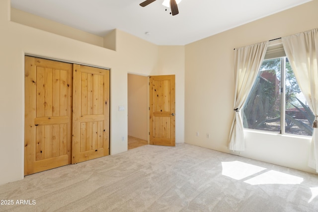 unfurnished bedroom featuring carpet flooring and ceiling fan