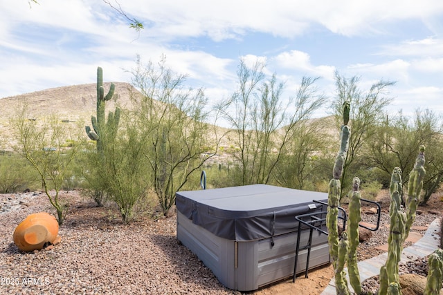 view of yard featuring a hot tub and a mountain view