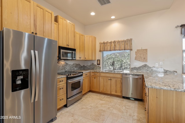 kitchen featuring light stone counters, a sink, stainless steel appliances, light tile patterned floors, and visible vents