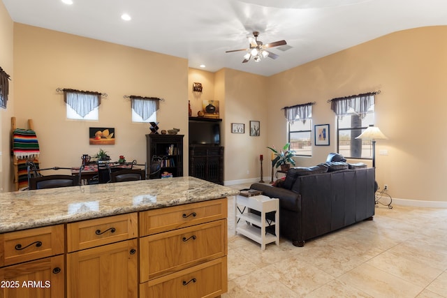 living area featuring recessed lighting, ceiling fan, and baseboards