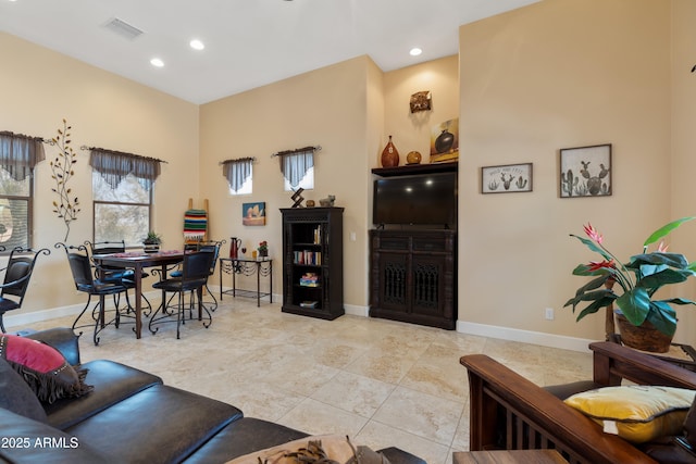 living area featuring recessed lighting, baseboards, and visible vents