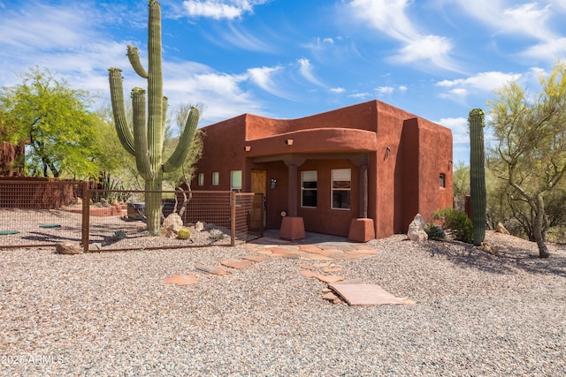 southwest-style home with fence