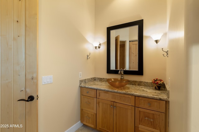 bathroom featuring vanity and baseboards