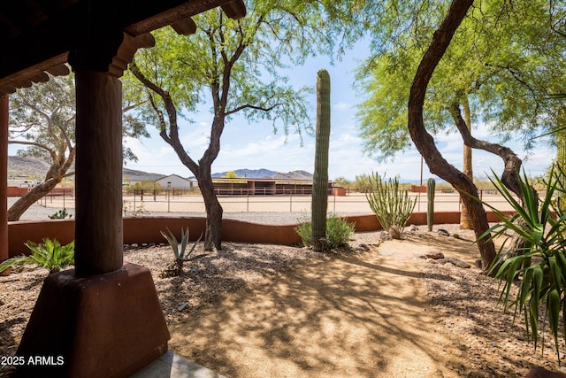 view of yard with a mountain view and a fenced backyard