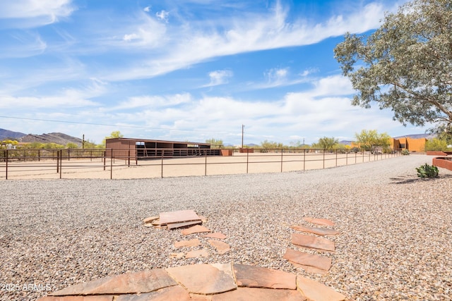 view of yard featuring an exterior structure, an outbuilding, and a mountain view
