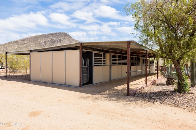 view of horse barn with a mountain view