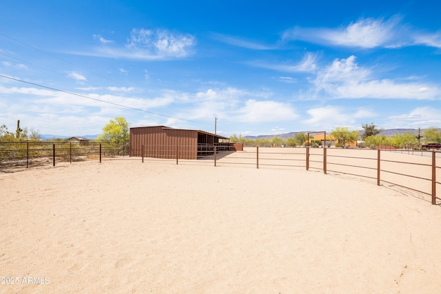 view of community with an outdoor structure, an exterior structure, and a rural view