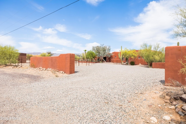 view of yard featuring fence and a gate
