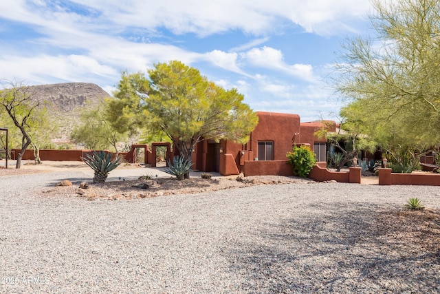 pueblo revival-style home with a mountain view