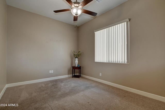 spare room featuring carpet flooring and ceiling fan