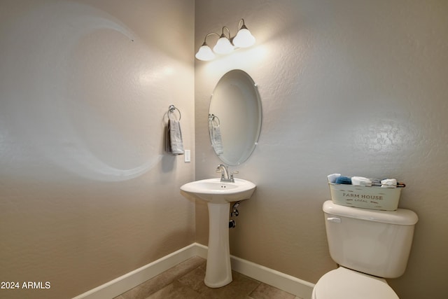 bathroom with tile patterned flooring and toilet