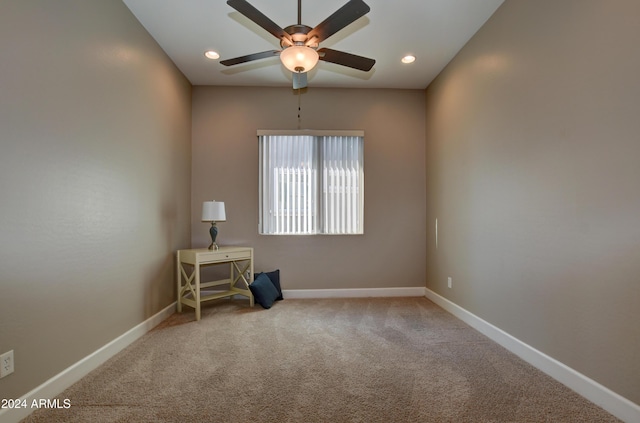 carpeted spare room featuring ceiling fan