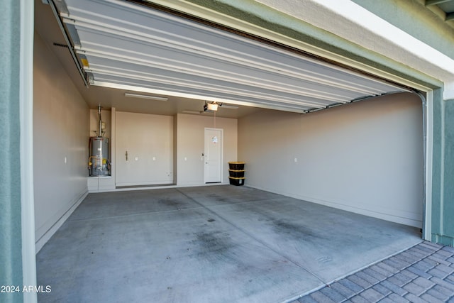 garage featuring water heater and a garage door opener