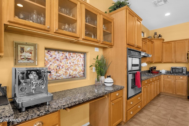 2069 E Winchester Way, Chandler, AZ 85286 - kitchen featuring appliances with stainless steel finishes, dark stone counters, glass insert cabinets, light tile patterned flooring, and recessed lighting