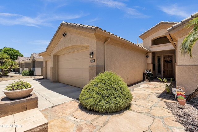 2069 E Winchester Way, Chandler, AZ 85286 - view of home's exterior featuring a garage, stucco siding, and a tiled roof