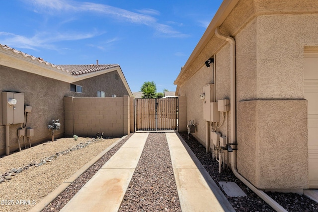 2069 E Winchester Way, Chandler, AZ 85286 - view of side of home with a gate and stucco siding