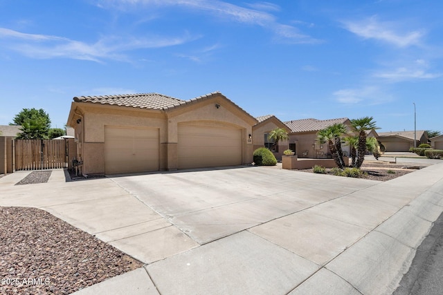 2069 E Winchester Way, Chandler, AZ 85286 - mediterranean / spanish home featuring a garage, driveway, a tiled roof, stucco siding, and a gate