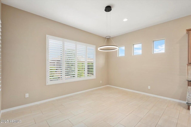 unfurnished room featuring baseboards