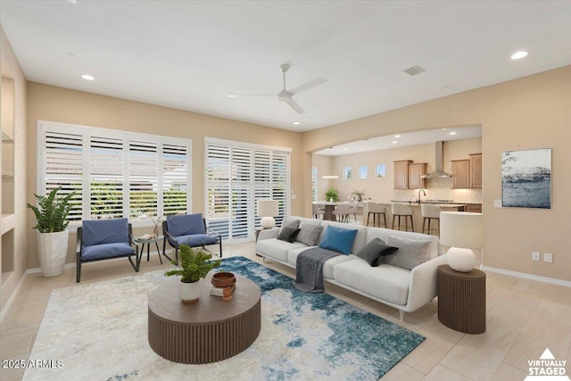 living room with baseboards, light tile patterned floors, a ceiling fan, and recessed lighting