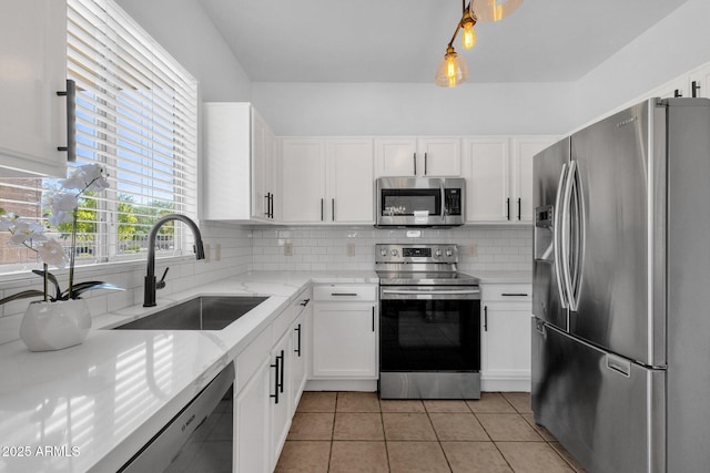 2545 E Harrison Ct, Gilbert, AZ 85295 - kitchen featuring stainless steel appliances, white cabinets, decorative backsplash, light stone countertops, and light tile patterned floors